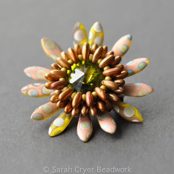 Beadwoven olive and copper peacock dagger brooch.