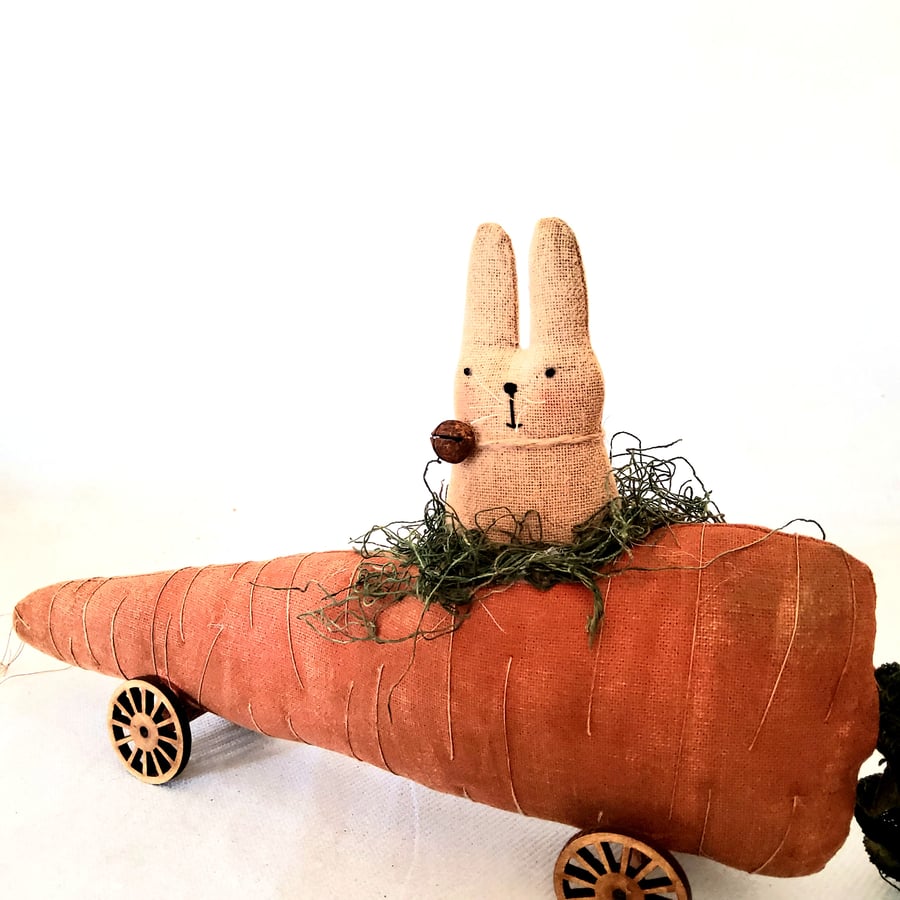 Primitive rabbit on a carrot on wheels