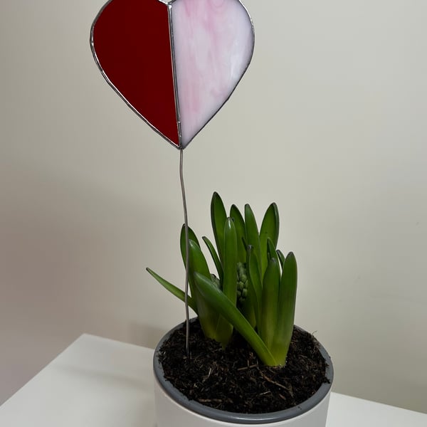 Heart in red stained glass on a stem