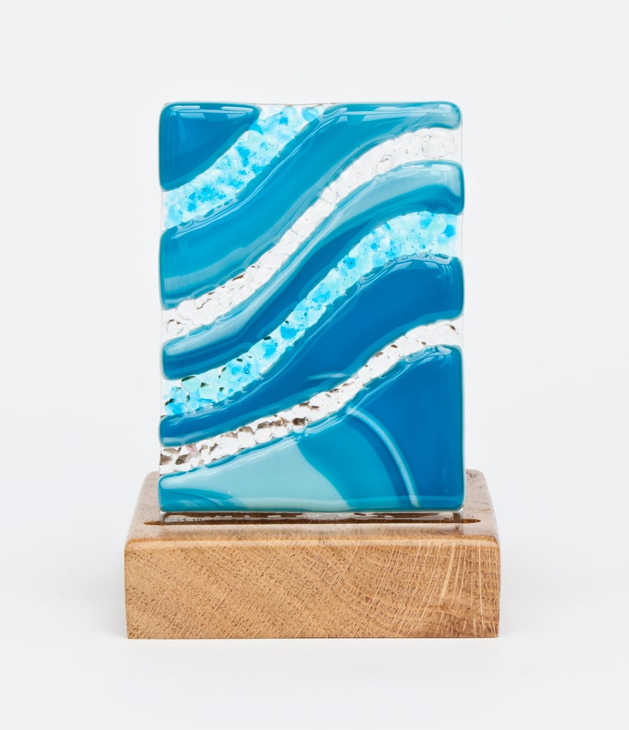 A Fused Glass Panel with a Wavy Teal Design set in an Oak Tealight Holder
