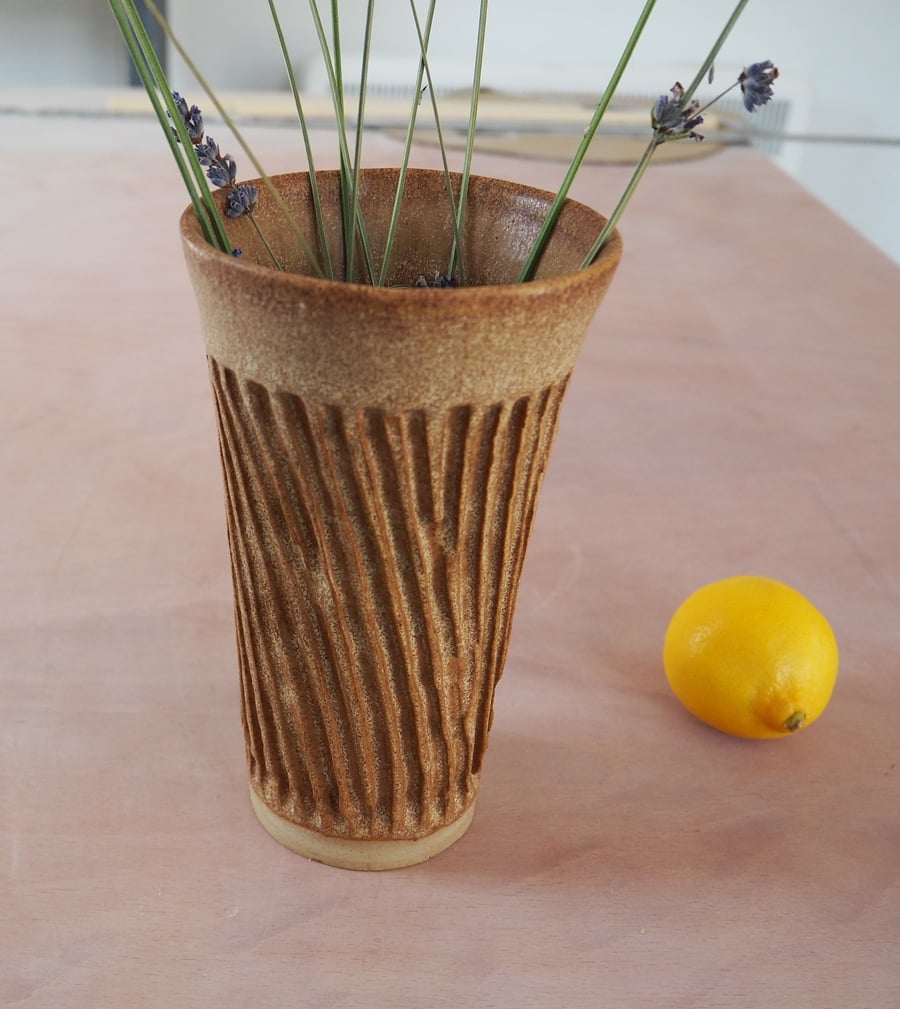 Pottery vase, textured with a brown glaze.