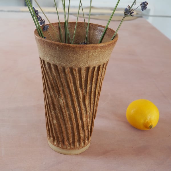 Pottery vase, textured with a brown glaze.