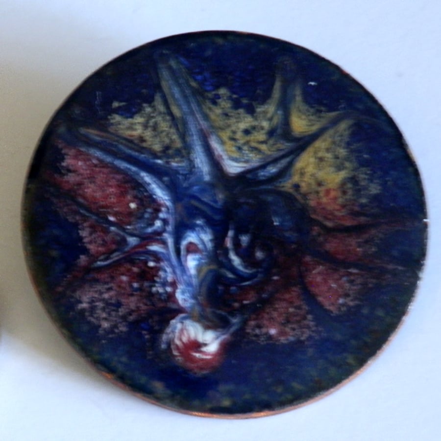 red, white, gold scrolled on dark blue - big round brooch