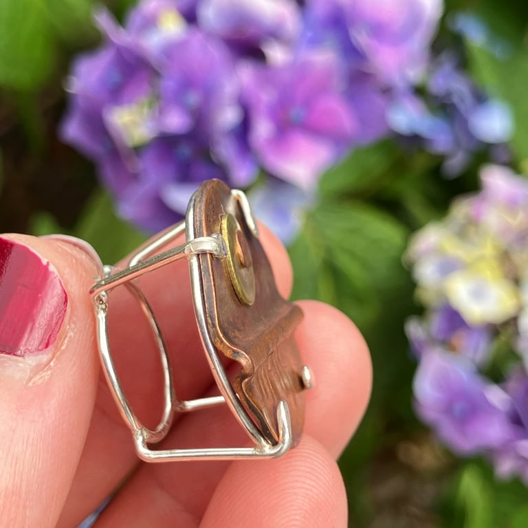 Patinated copper, brass and sterling silver brooch. 