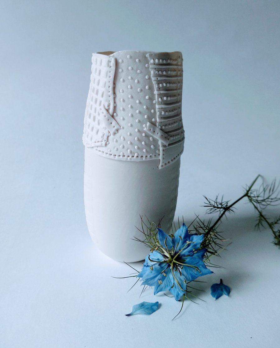 Delicate porcelain vase with resist and impressed decoration