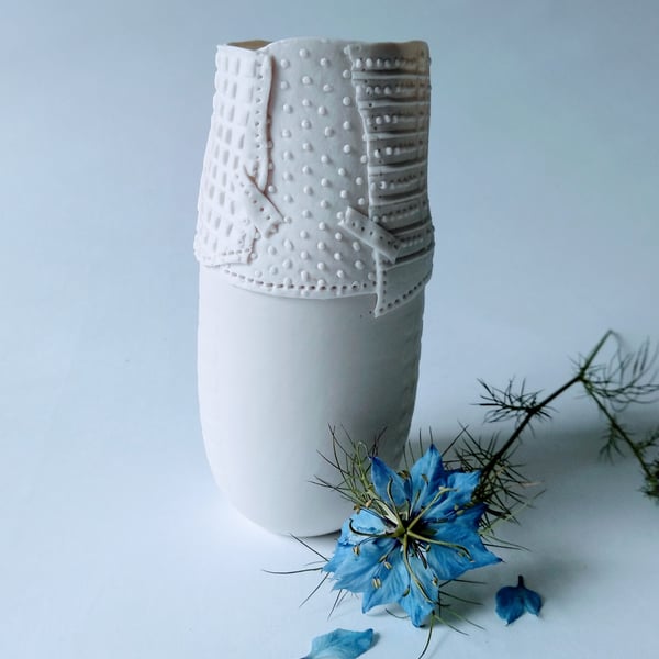 Delicate porcelain vase with resist and impressed decoration