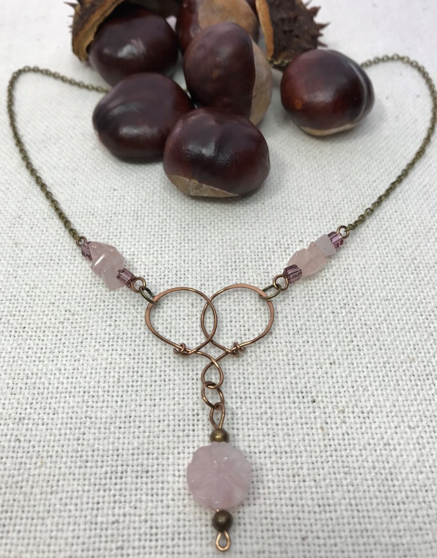 A handmade necklace pendant in antique bronze wirework & Rose Quartz beads