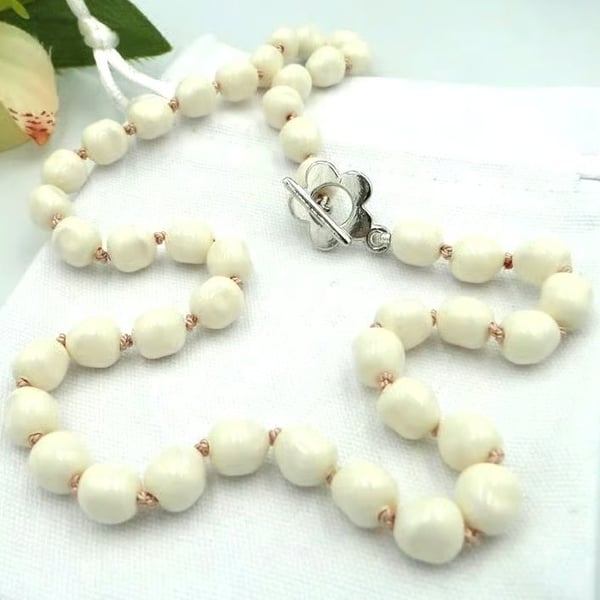 Cream glass pearl necklace  Traditionally knotted with pink silk thread 