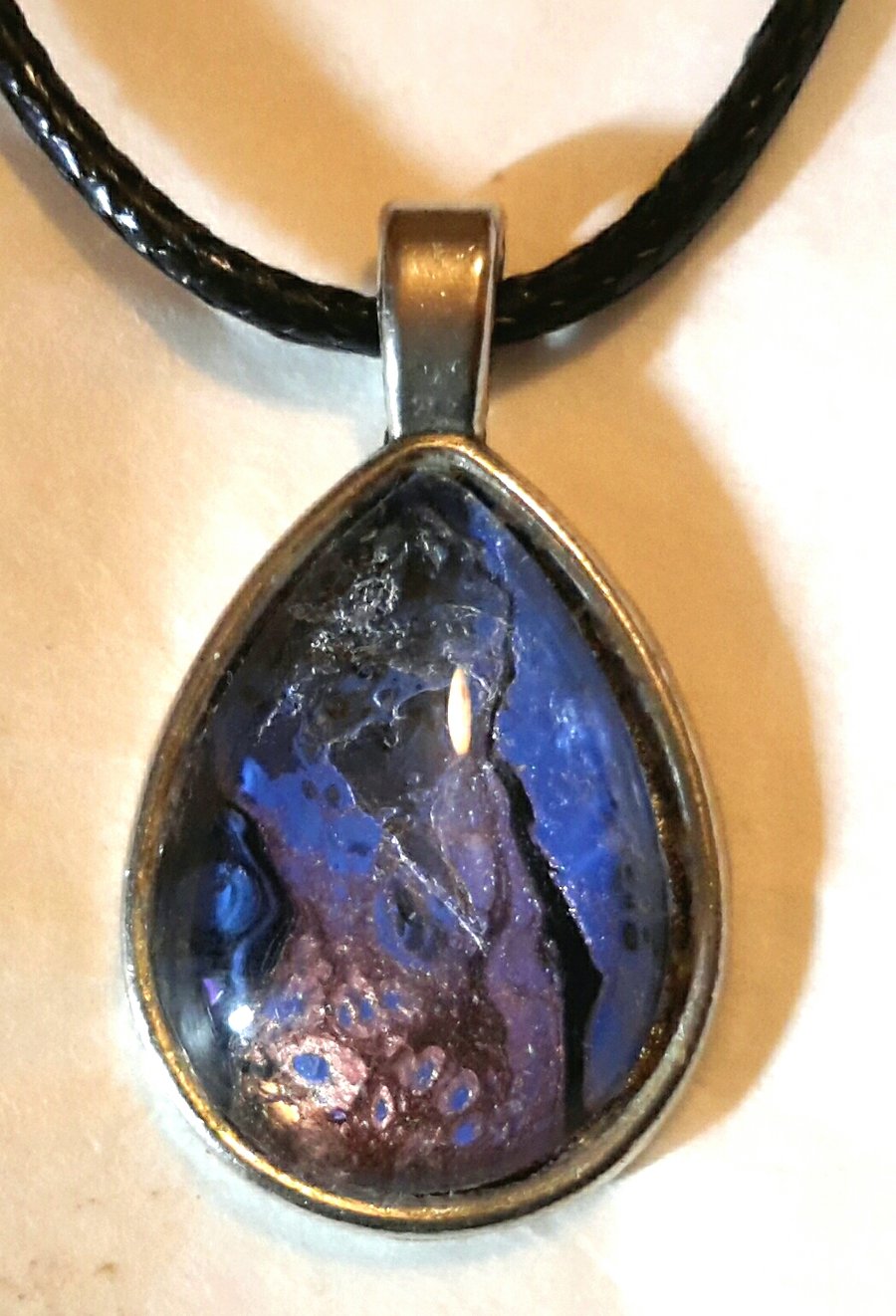 Handmade blue and purple fluid art teardrop pendant.