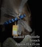 Banded damoiselle brooch