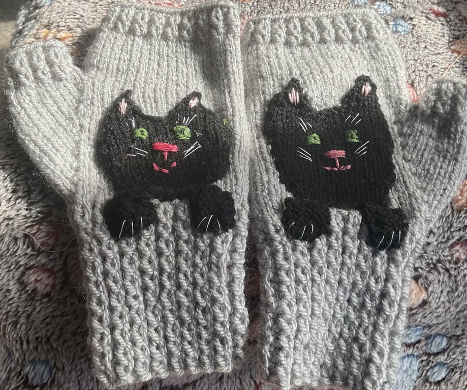 Grey mittens for adult or teenager with a black cat face and paws 