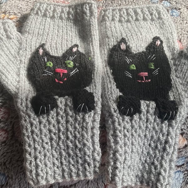 Grey mittens for adult or teenager with a black cat face and paws 