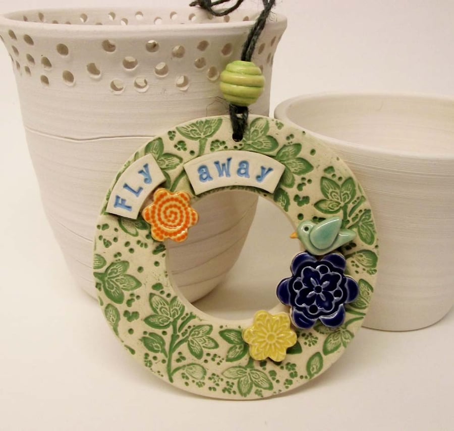 Ceramic decoration with bird and flowers