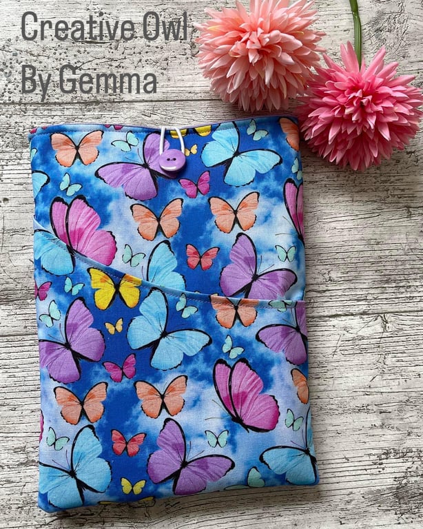 Fabric book sleeve with pocket for paperback books. Padded and fully lined.