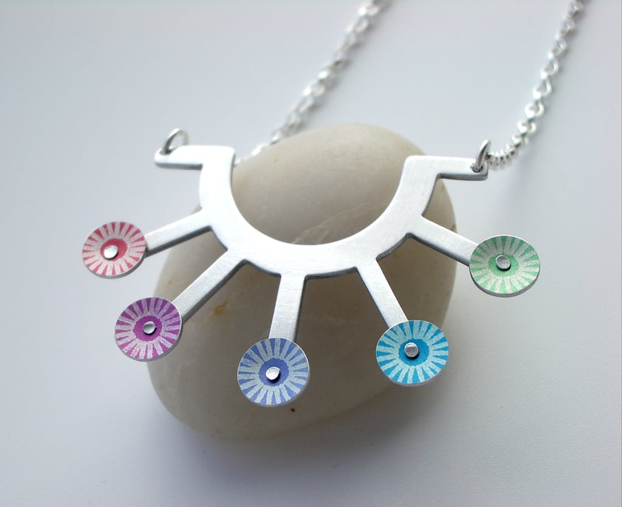 Sunburst necklace with riveted rainbow circles