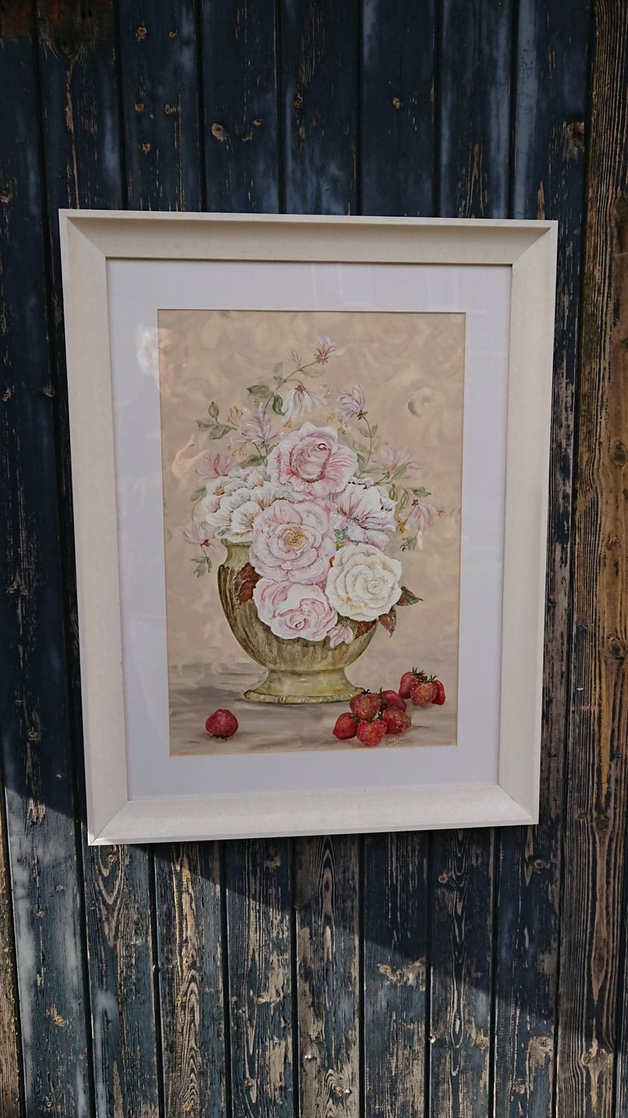 Cabbage roses in pottery bowl with strawberries