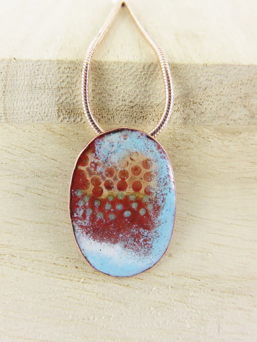 Oval copper and enamel pendant with textured copper detail