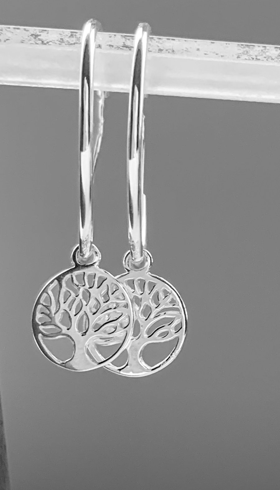 Sterling silver hoop earrings with tree of life charm