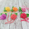 6 crocheted flower buds with leaves