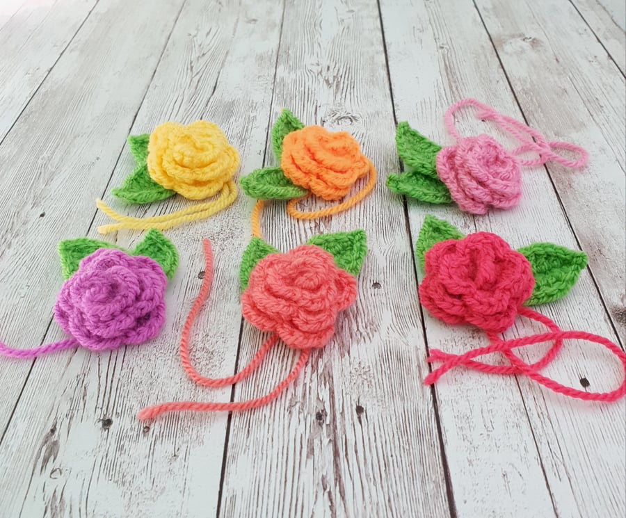 6 crocheted flower buds with leaves