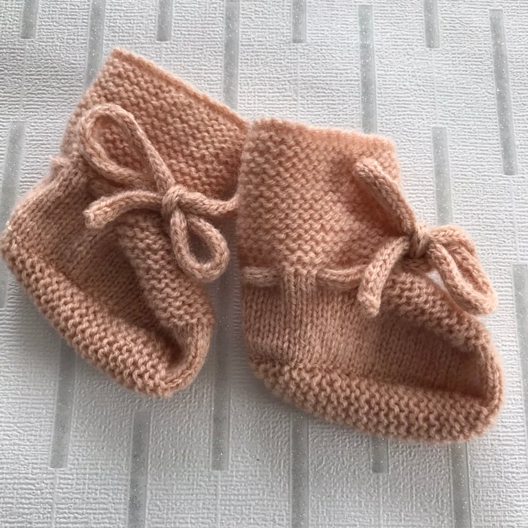 Hand knitted peach coloured bootees