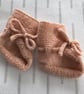 Hand knitted peach coloured bootees - Image 1