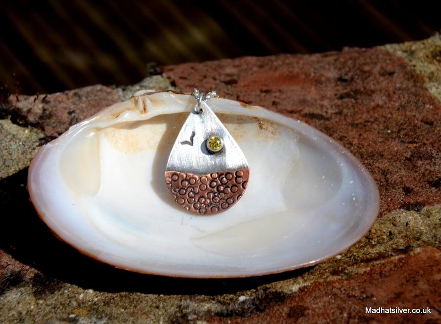Silver and copper teardrop shape beach pendant with sparkling sun