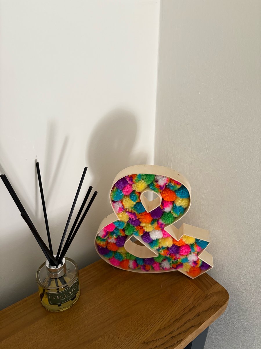 Wooden Pom Pom filled Ampersand sign.  