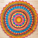 Large, bright crochet mandala doily table mat
