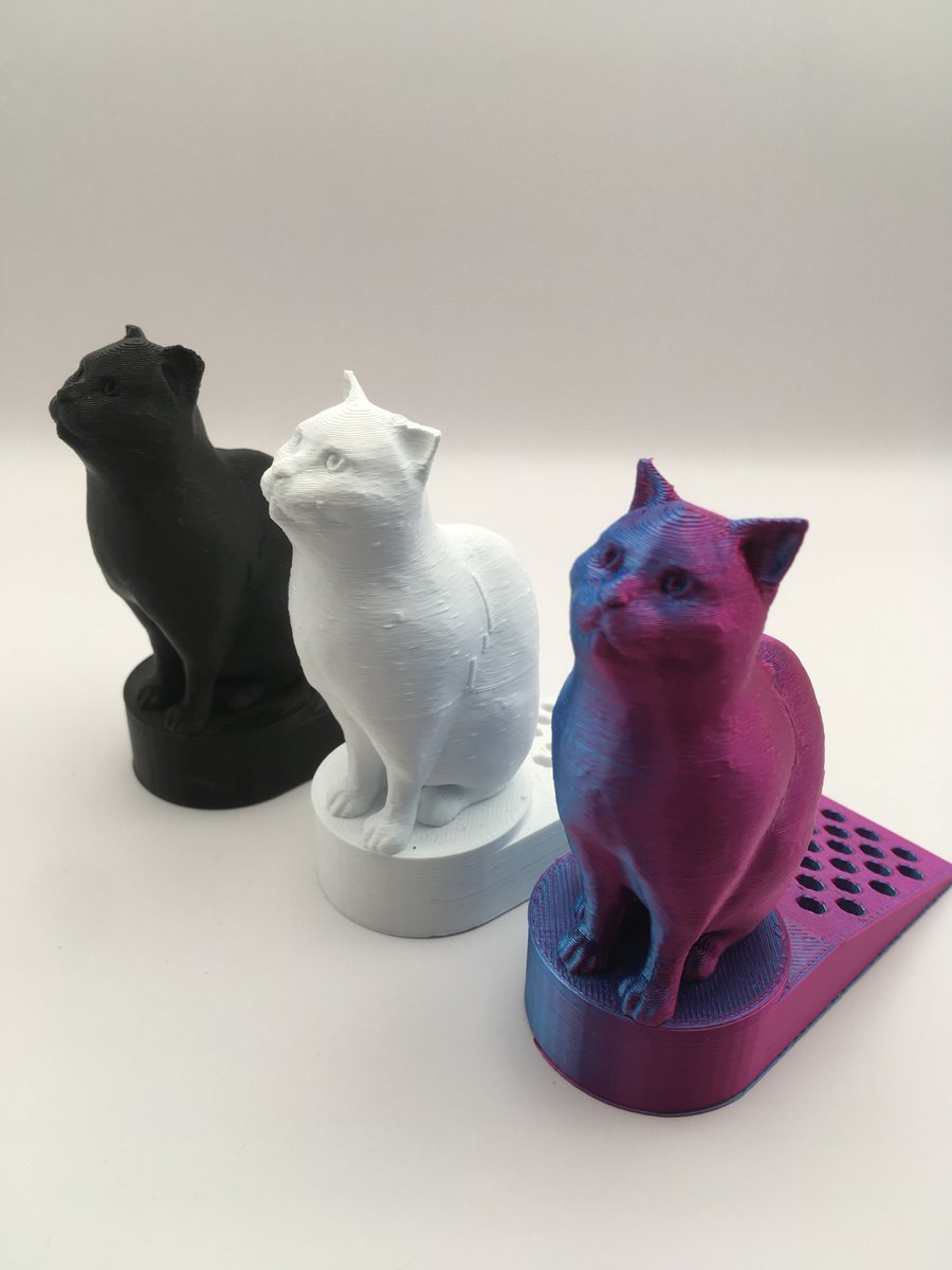 3d printed cat doorstop in various colours.