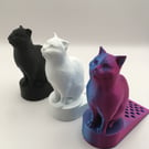 3d printed cat doorstop in various colours.