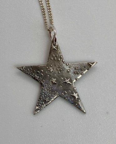 Silver star necklace with embossed tiny stars