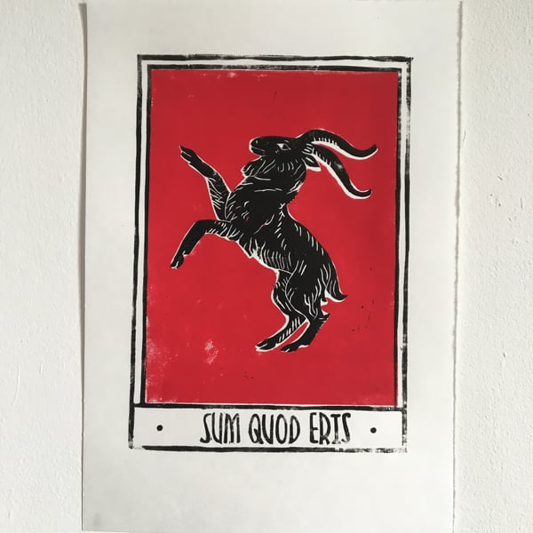 Sum Quod Eris, linocut print black goat with a red background on handmade paper