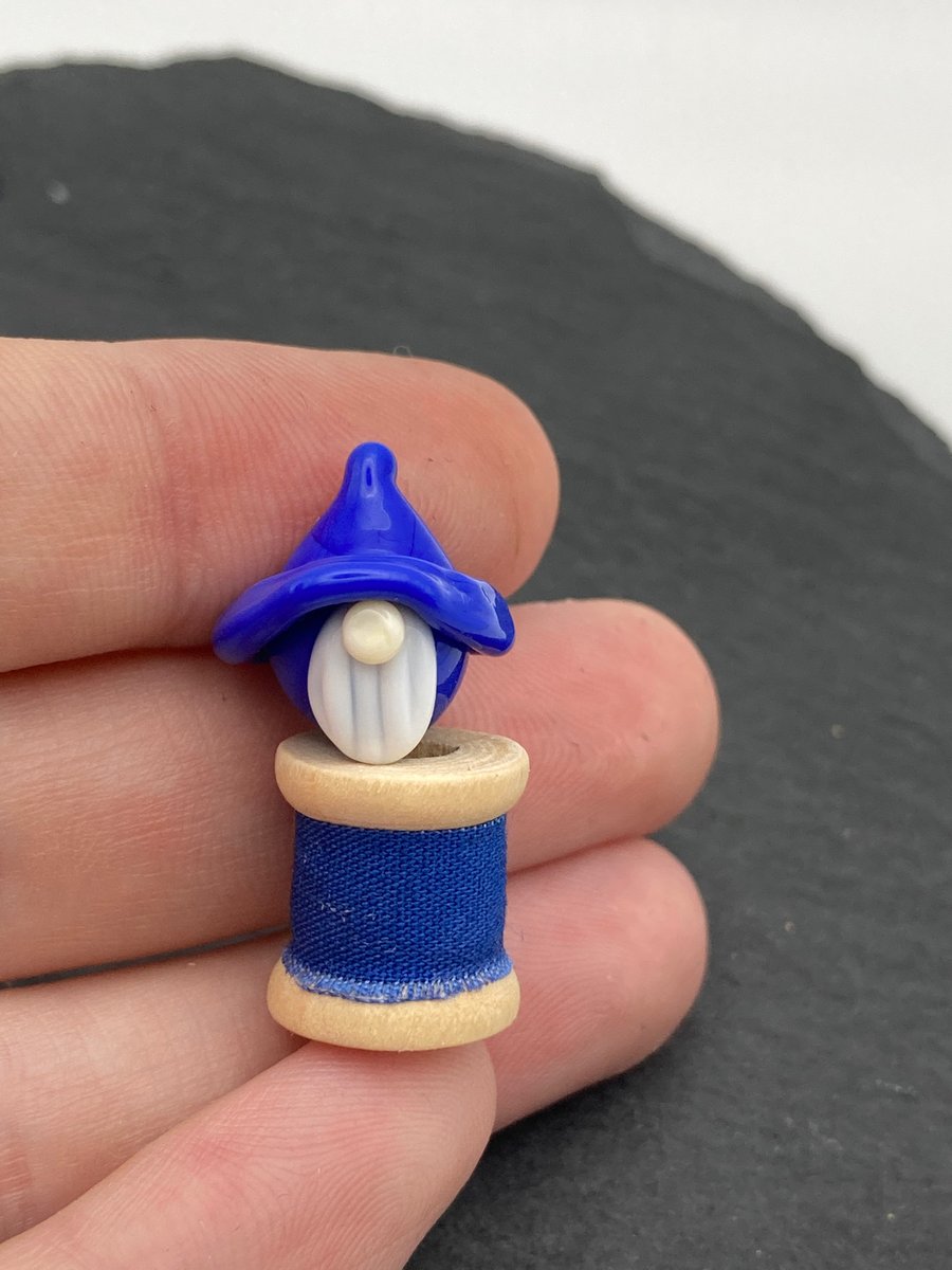 small gnome on a wooden bobbin