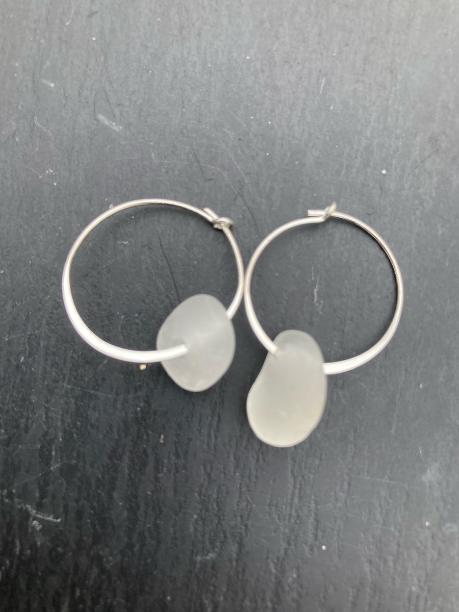 Sterling silver hoop earrings with white seaglass drops.