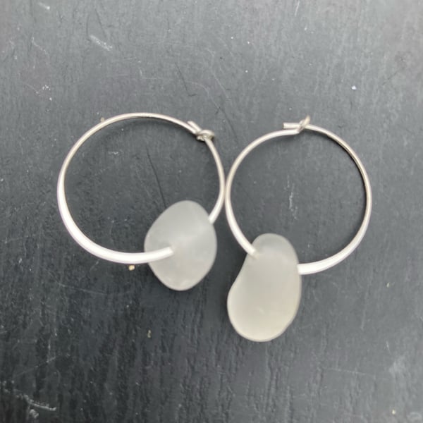 Sterling silver hoop earrings with white seaglass drops.