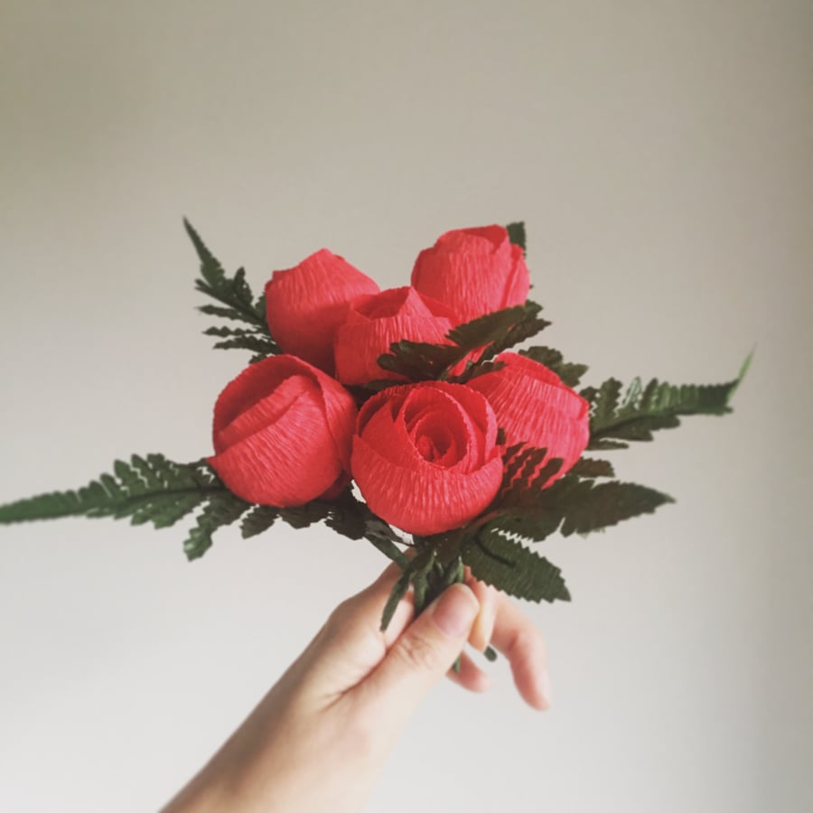 A posy of red paper roses