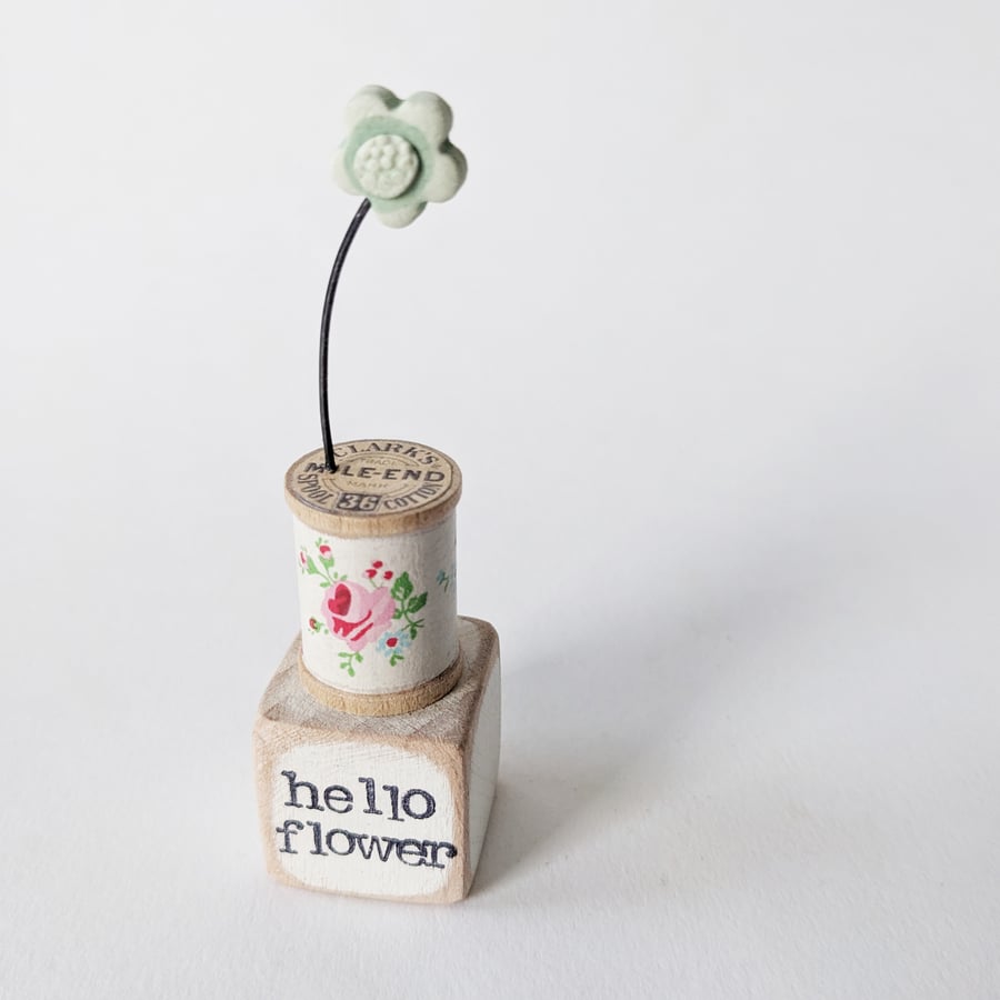 Clay Flower on a Teeny Vintage Bobbin 'hello flower'