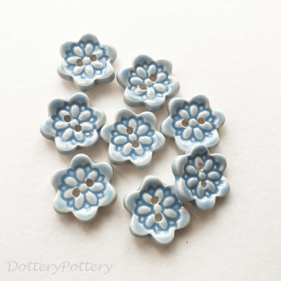 Set of eight little handmade ceramic buttons blue