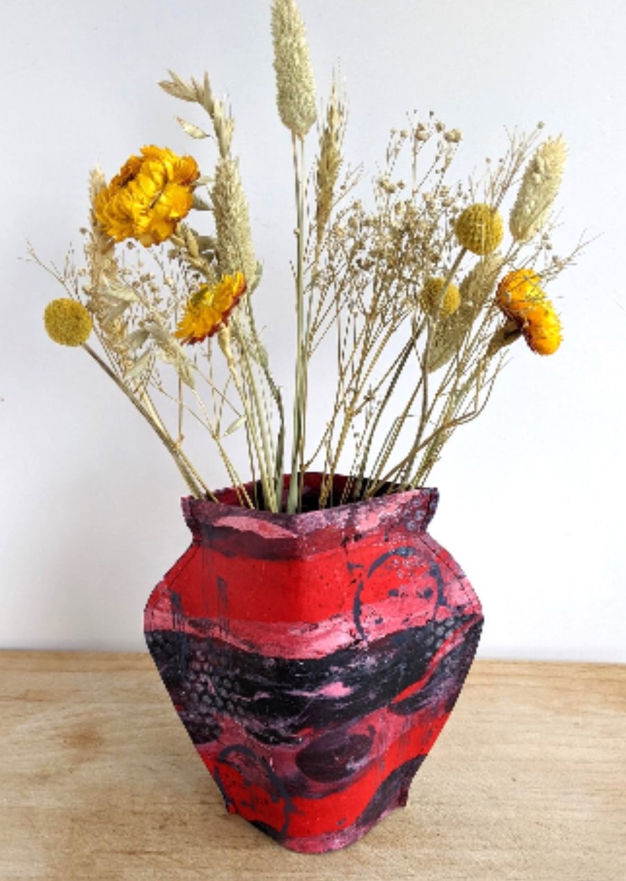 Paper vase cover, deep reds and black abstract design