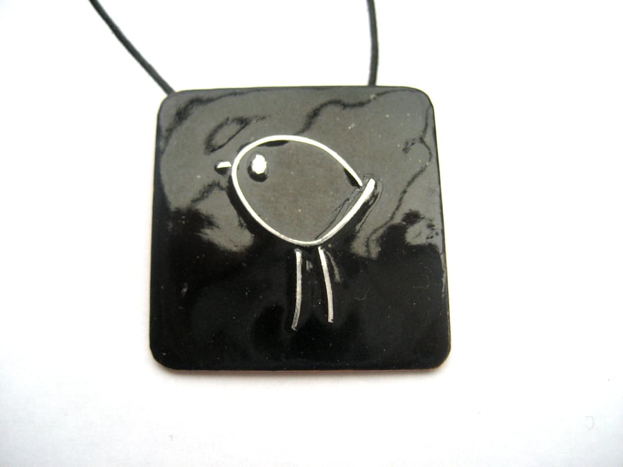 Silver bird on black enamelled pendant