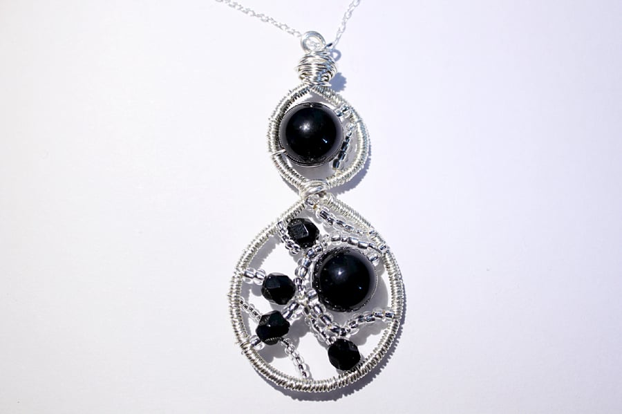 Black and silver wire wrapped and woven pendant with sterling silver chain