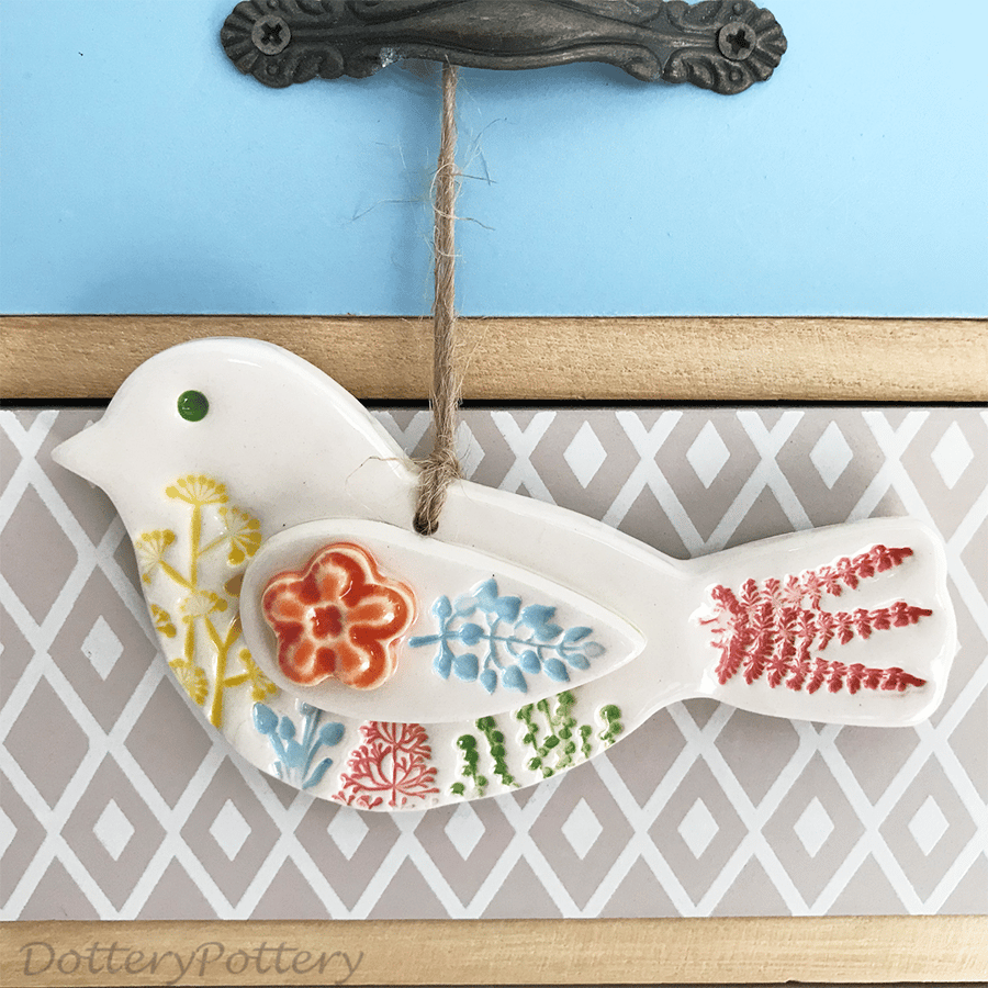 Ceramic bird hanging decoration with orange flower detail