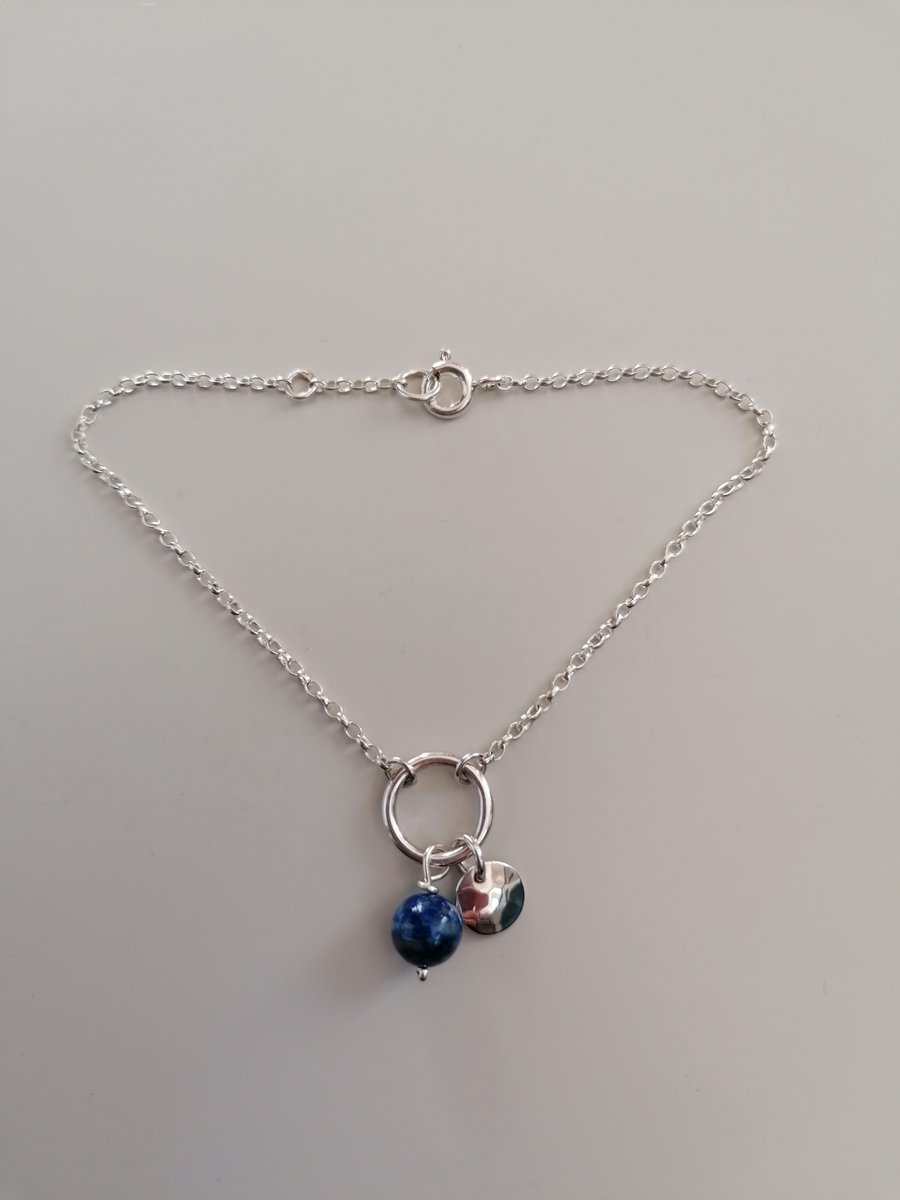 Wire circle bracelet with a disc and Lapis bead