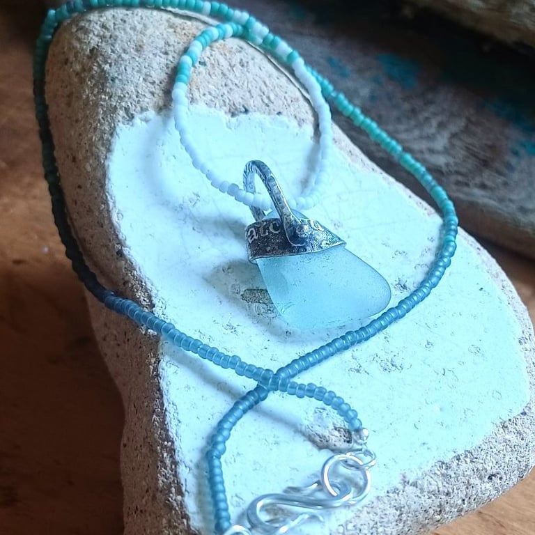 Frosty aqua sea glass, silver and seed-bead swivel necklace pendant.