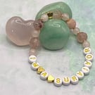 'I'm A Survivor' stretchy bracelet with rose quartz and strawberry quartz stones