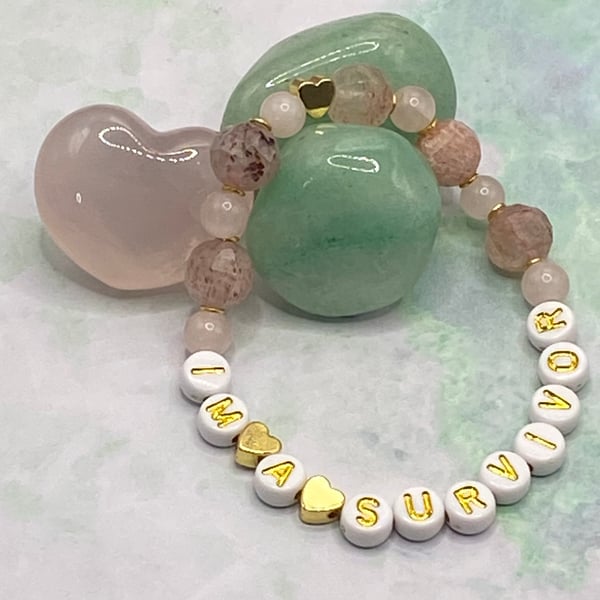 'I'm A Survivor' stretchy bracelet with rose quartz and strawberry quartz stones