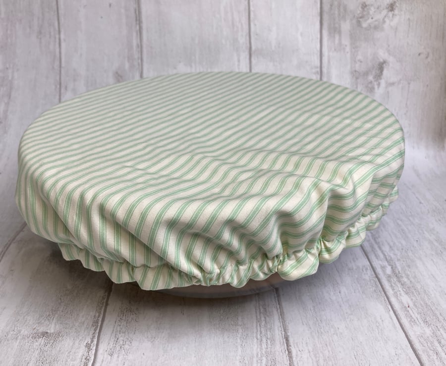 One extra large reusable bowl cover to fit a mixing bowl. Sage green stripes