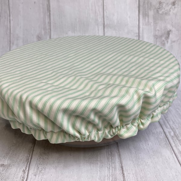 One extra large reusable bowl cover to fit a mixing bowl. Sage green stripes