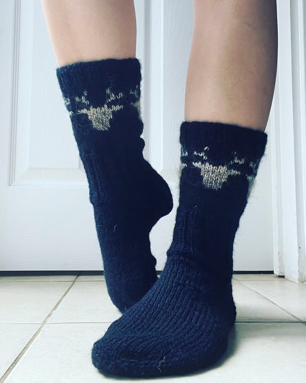 Hand knit black wool socks with beige reindeer pattern fairisle nordic christmas